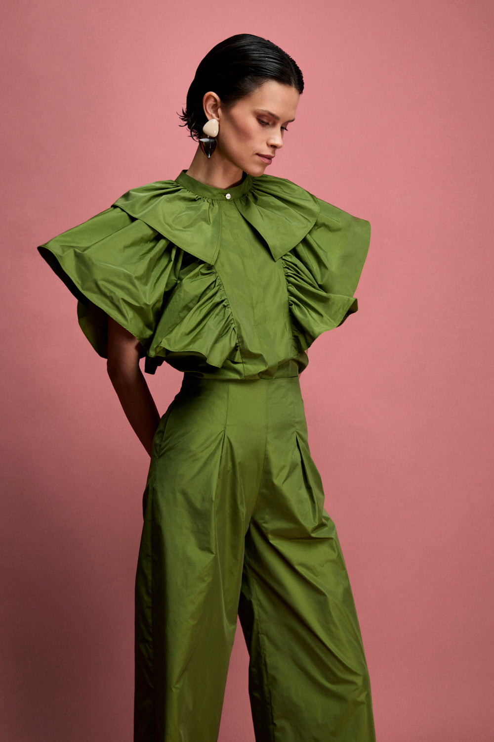 Pantalón de talle alto confeccionado en tafeta en color carmín. Este pantalón es tobillero y tiene pinzas en el delantero.